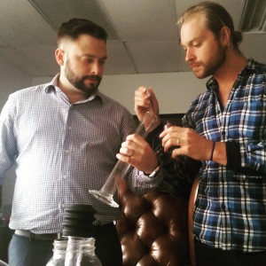 Beakers and pipettes and trial and error have fueled OTR's cocktail creations. Here, Halbert and Gill test a new mixture at OTR's offices.