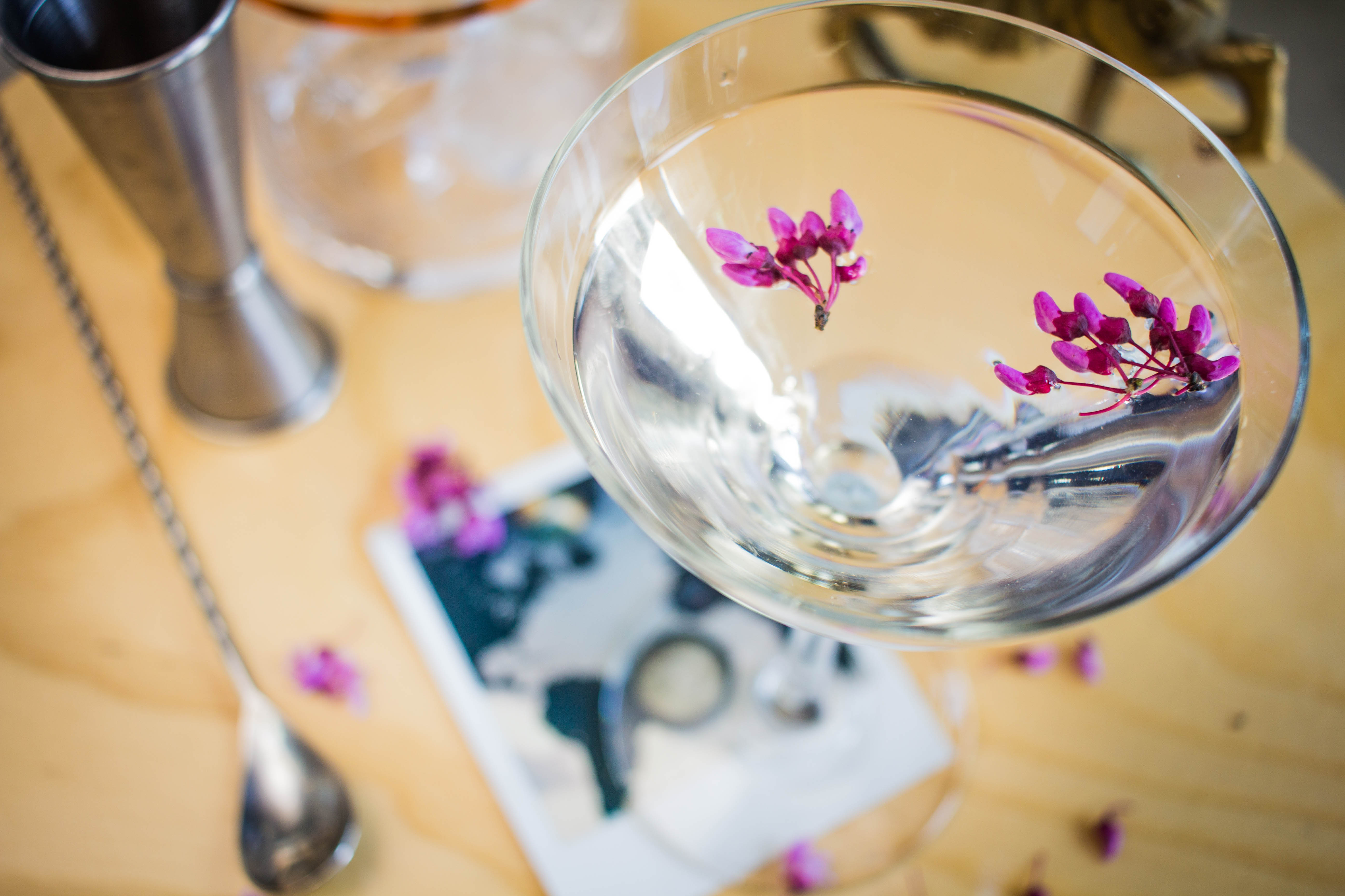 Tequila mockingbird garnished with edible flowers and dehydrated